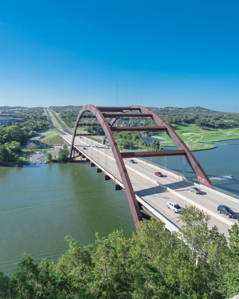 pennybacker bridge over colorado river and hill country landscape in austin