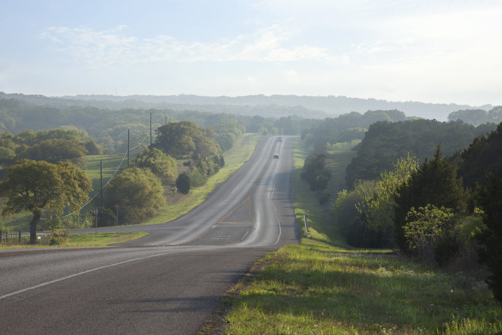 road in the texas hill country near sundown